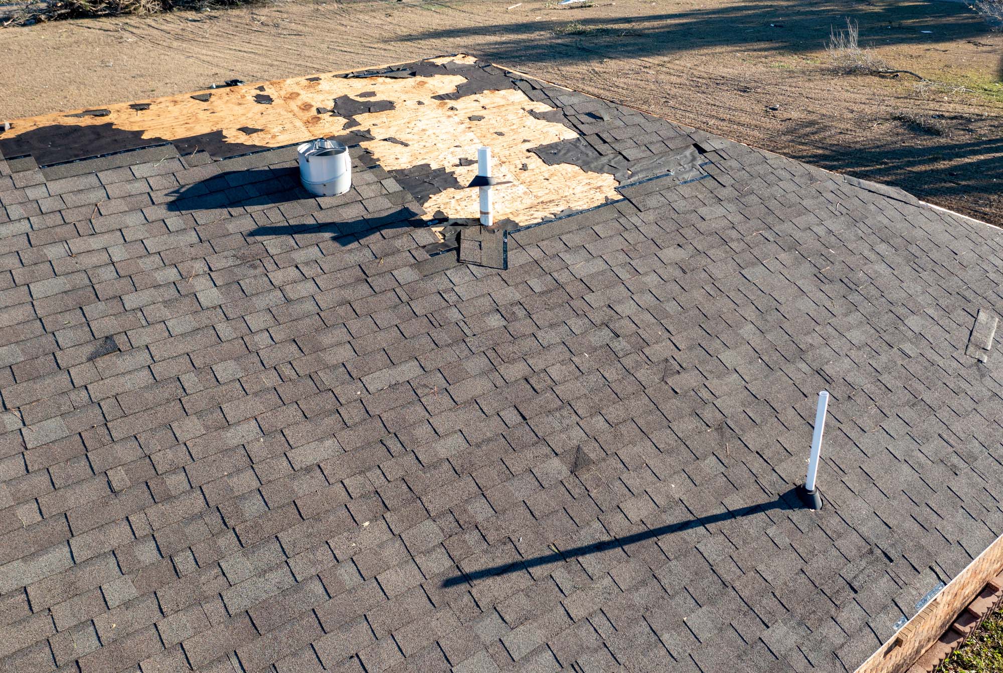 Roof and shingles damaged by tornado during severe weather
